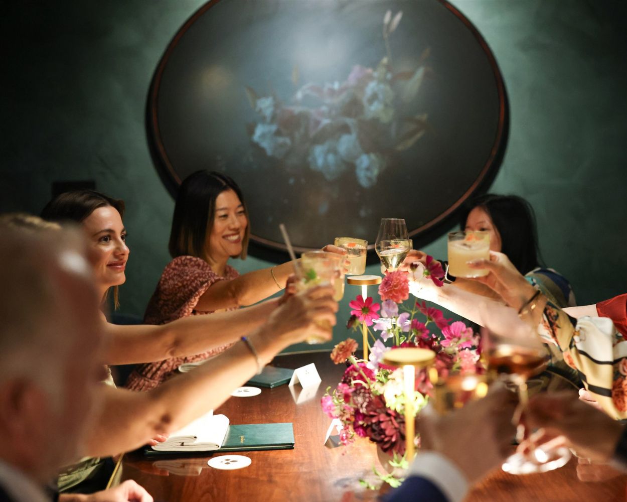 People with drinks at a dinner table